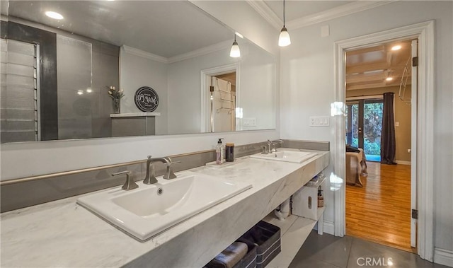 bathroom with hardwood / wood-style floors, vanity, and ornamental molding