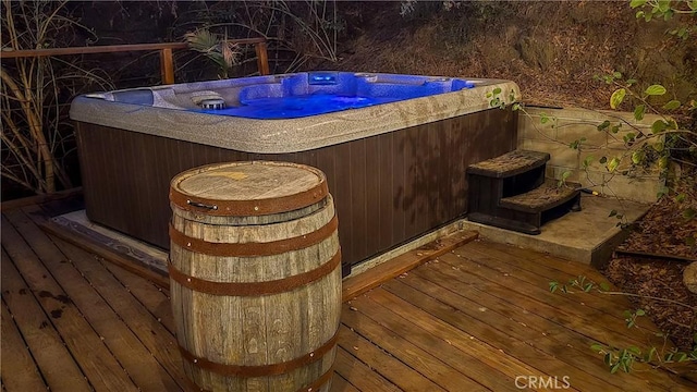 wooden deck with a hot tub