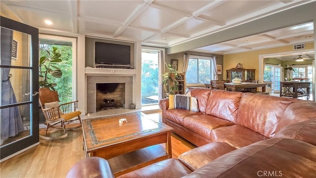 living room featuring hardwood / wood-style flooring, plenty of natural light, and coffered ceiling