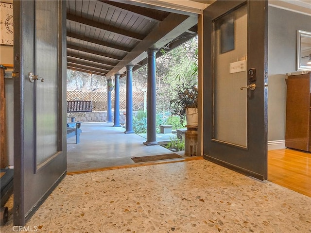 entryway featuring wood ceiling, hardwood / wood-style floors, beamed ceiling, and a healthy amount of sunlight