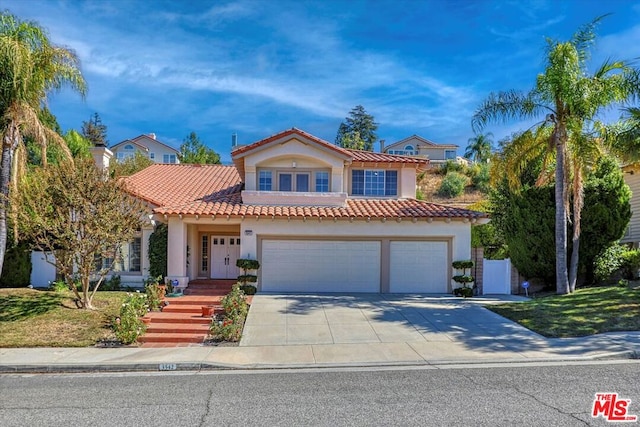 mediterranean / spanish home with a garage