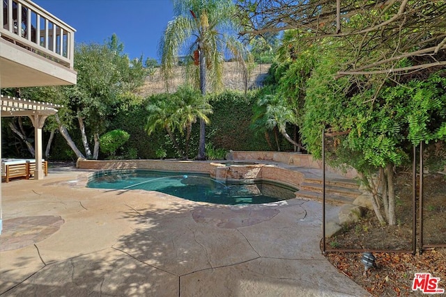 view of swimming pool featuring a patio area, a pergola, and an in ground hot tub