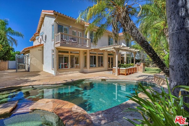 rear view of house featuring a patio area, a balcony, and a pergola