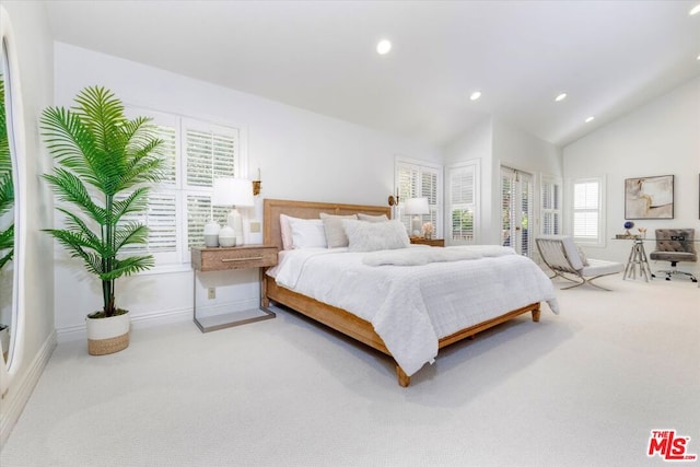 carpeted bedroom featuring lofted ceiling