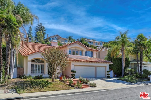 mediterranean / spanish home featuring a garage