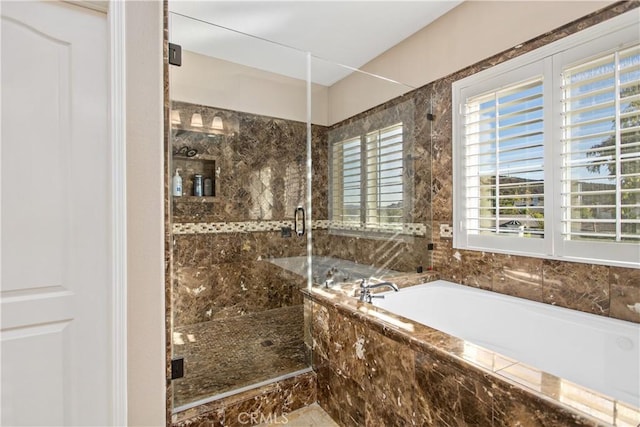 bathroom featuring independent shower and bath