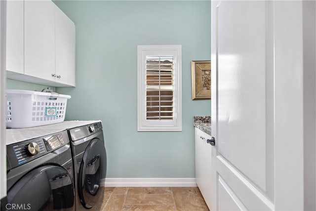 laundry area with cabinets and washer and clothes dryer