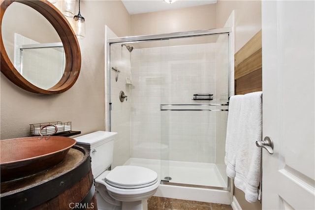 bathroom featuring vanity, toilet, and an enclosed shower