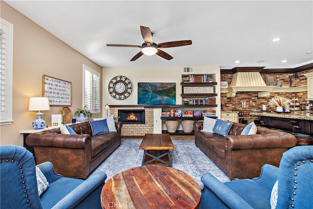 living room featuring ceiling fan and brick wall