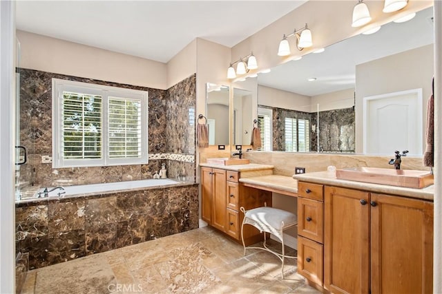 bathroom with vanity and tiled tub