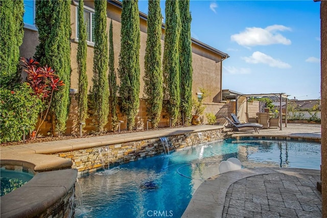 view of pool with pool water feature and a patio