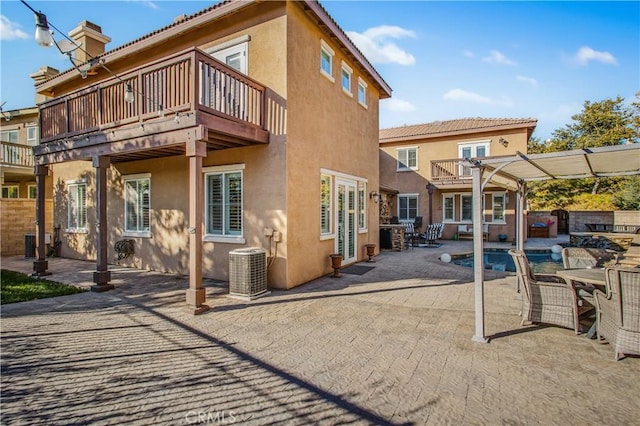 rear view of property featuring a patio area, a balcony, a pergola, and cooling unit