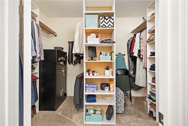 walk in closet featuring light colored carpet