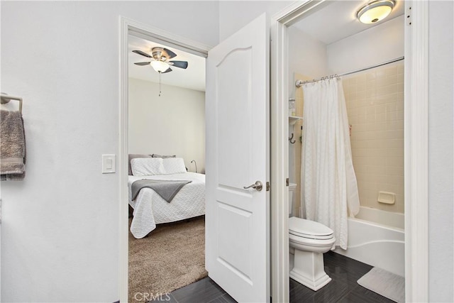 bathroom with ceiling fan, shower / bath combo with shower curtain, and toilet