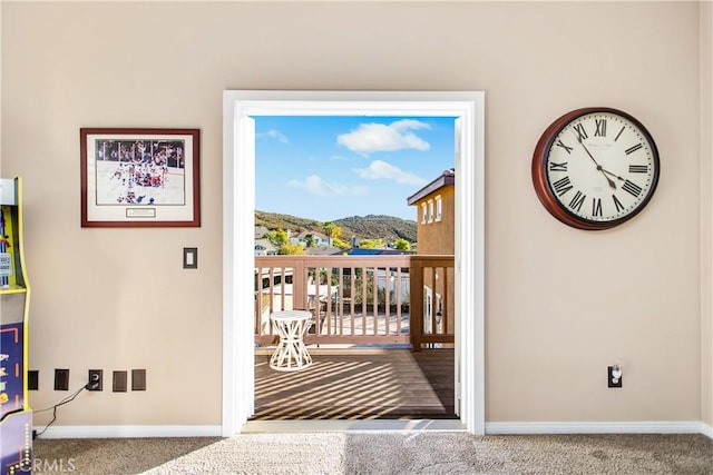 doorway to outside featuring carpet and a mountain view