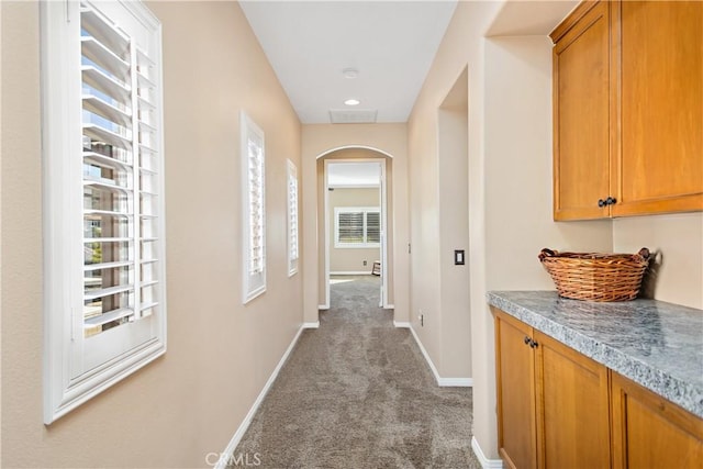 corridor with light colored carpet