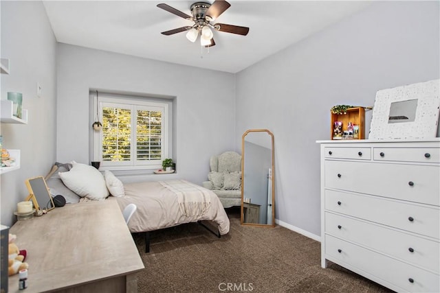 bedroom featuring ceiling fan and dark carpet