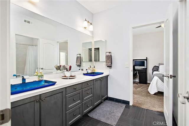 bathroom featuring ceiling fan and vanity