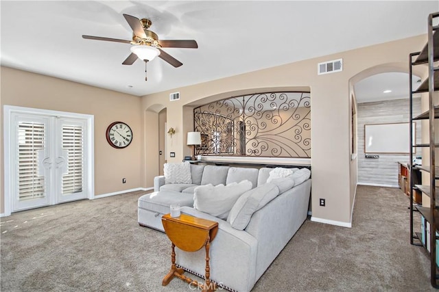 living room with ceiling fan and carpet floors