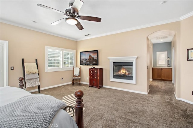 carpeted bedroom featuring ceiling fan and ornamental molding