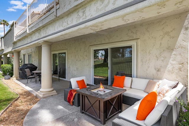 view of patio / terrace featuring an outdoor living space with a fire pit, a balcony, and area for grilling