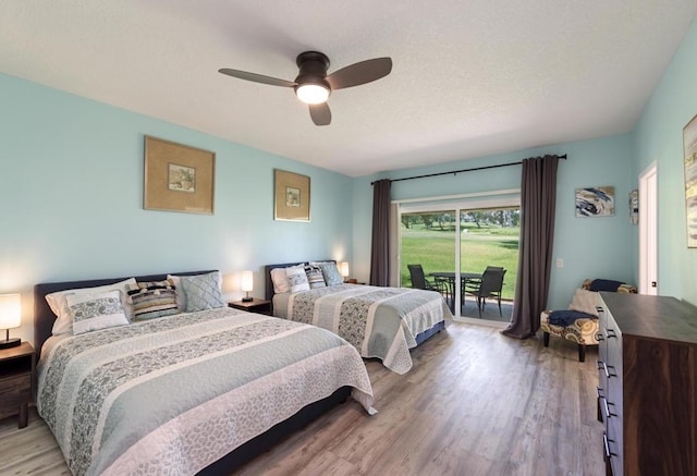 bedroom with ceiling fan, access to exterior, and hardwood / wood-style floors