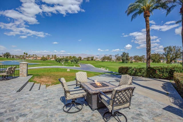 view of patio / terrace with a mountain view and a fire pit