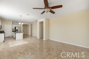 unfurnished living room featuring ceiling fan