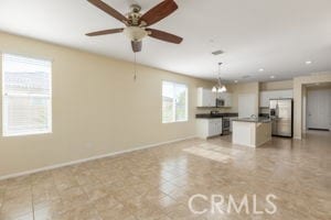 unfurnished living room with ceiling fan