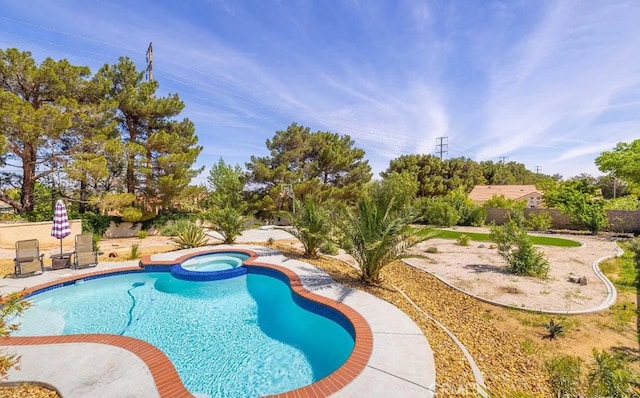 view of swimming pool with an in ground hot tub