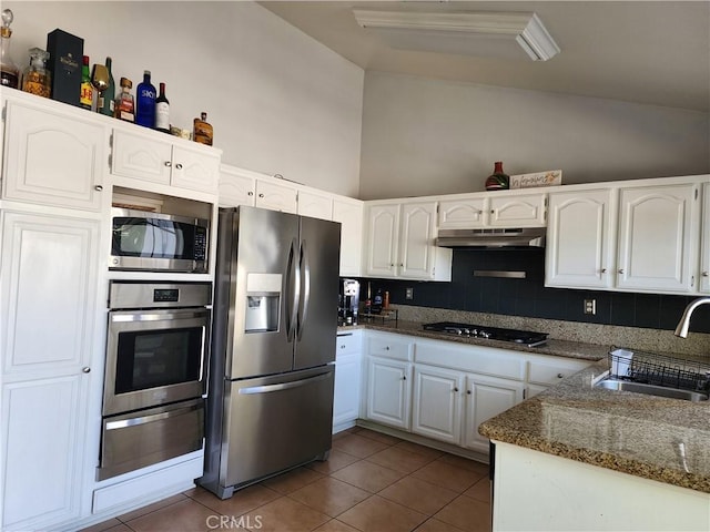 kitchen featuring white cabinets, dark tile patterned flooring, sink, and stainless steel appliances