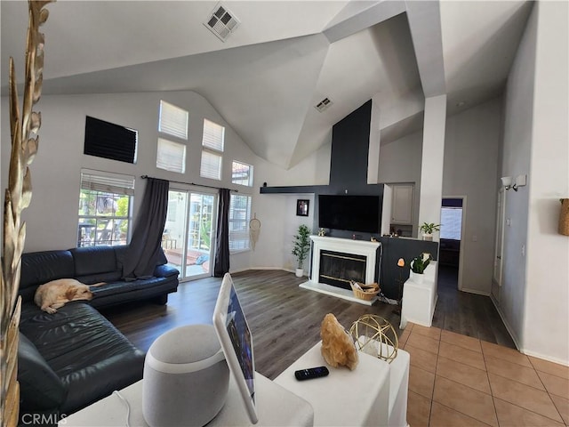 living room featuring tile patterned floors and high vaulted ceiling