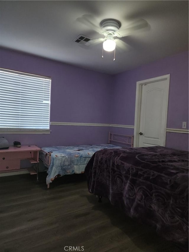 bedroom with dark wood-type flooring and ceiling fan