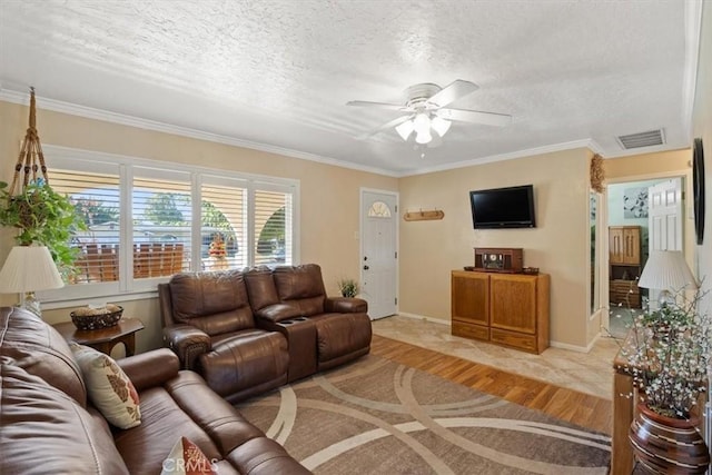 living room featuring ceiling fan, light hardwood / wood-style floors, ornamental molding, and a textured ceiling