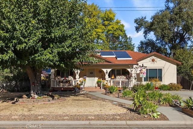 view of front of property with solar panels and a porch