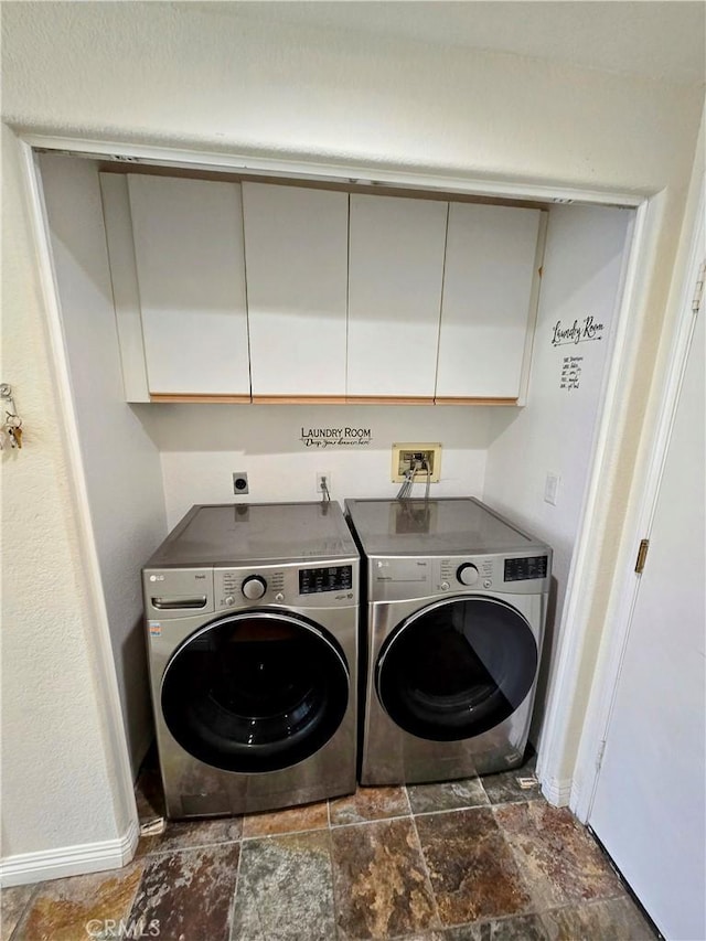 laundry area with washer and dryer and cabinets