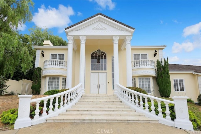 greek revival house with a balcony