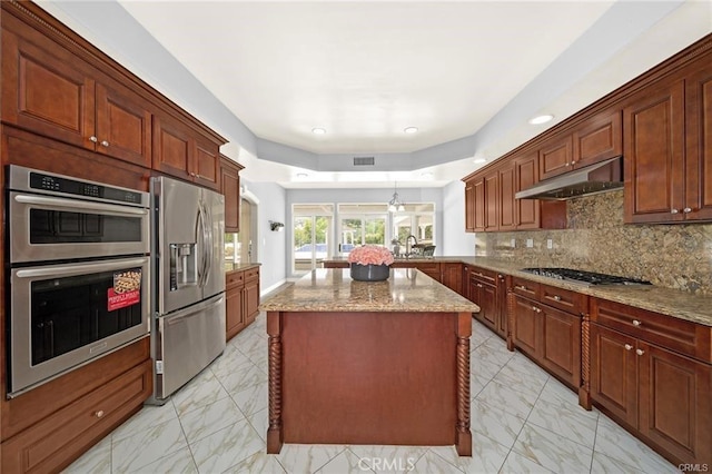 22427 Steeplechase Ln, Diamond Bar, CA 91765 - kitchen featuring appliances with stainless steel finishes, under cabinet range hood, light marble finish flooring, light stone countertops, and a peninsula