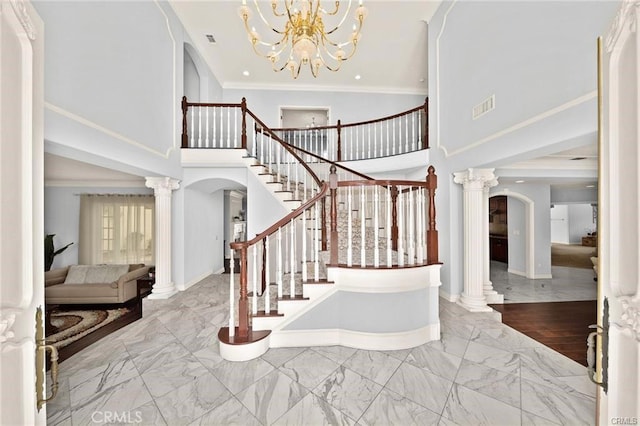 22427 Steeplechase Ln, Diamond Bar, CA 91765 - foyer with arched walkways, a towering ceiling, marble finish floors, stairway, and a chandelier