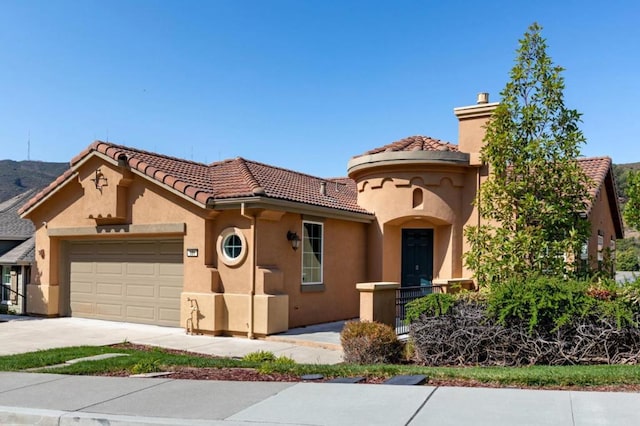 mediterranean / spanish-style home with a garage