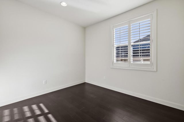 unfurnished room with dark hardwood / wood-style floors