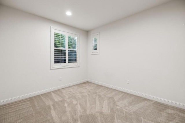 unfurnished room featuring light colored carpet