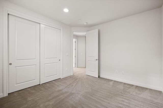 unfurnished bedroom with carpet and a closet