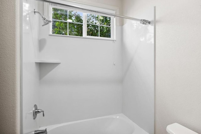 bathroom with shower / bathtub combination and toilet