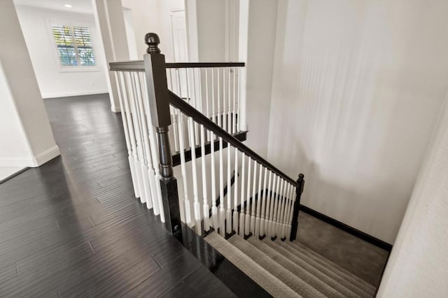 staircase featuring wood-type flooring