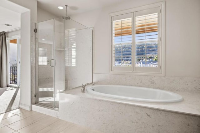 bathroom featuring plus walk in shower and tile patterned floors