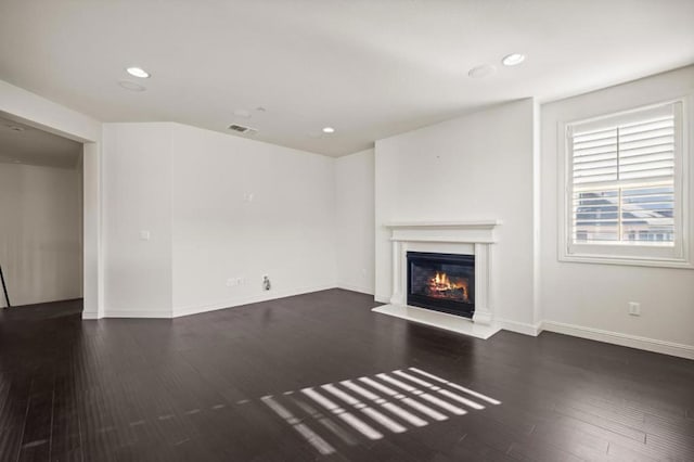 unfurnished living room featuring dark hardwood / wood-style floors