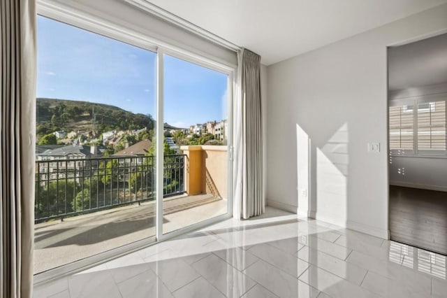 spare room featuring light tile patterned flooring