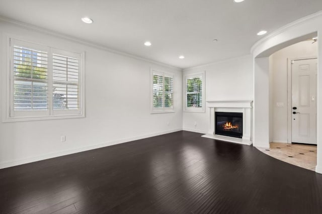 unfurnished living room featuring crown molding, hardwood / wood-style floors, and a healthy amount of sunlight