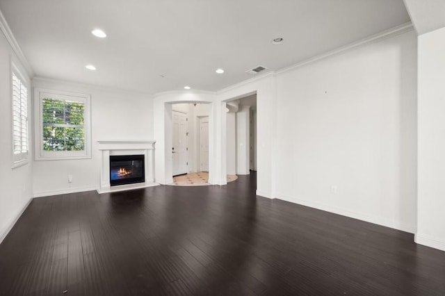 unfurnished living room featuring dark hardwood / wood-style floors and crown molding